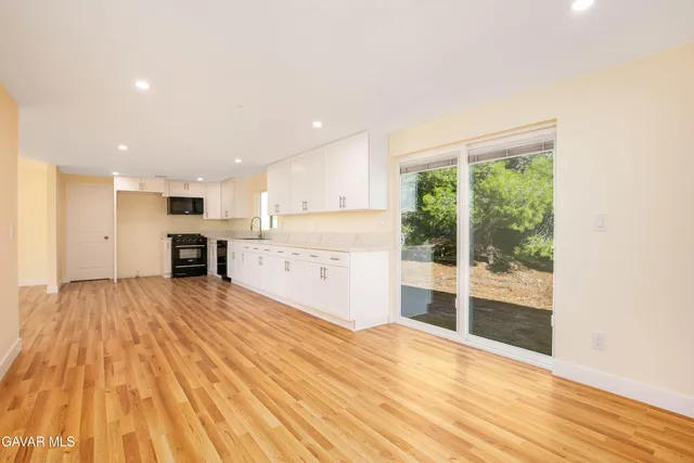 a view of a kitchen with wooden floor and a kitchen