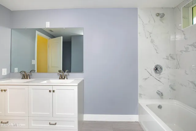 a bathroom with a bathtub and a sink