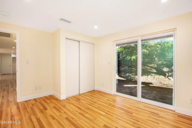 a view of wooden floor and windows in a room