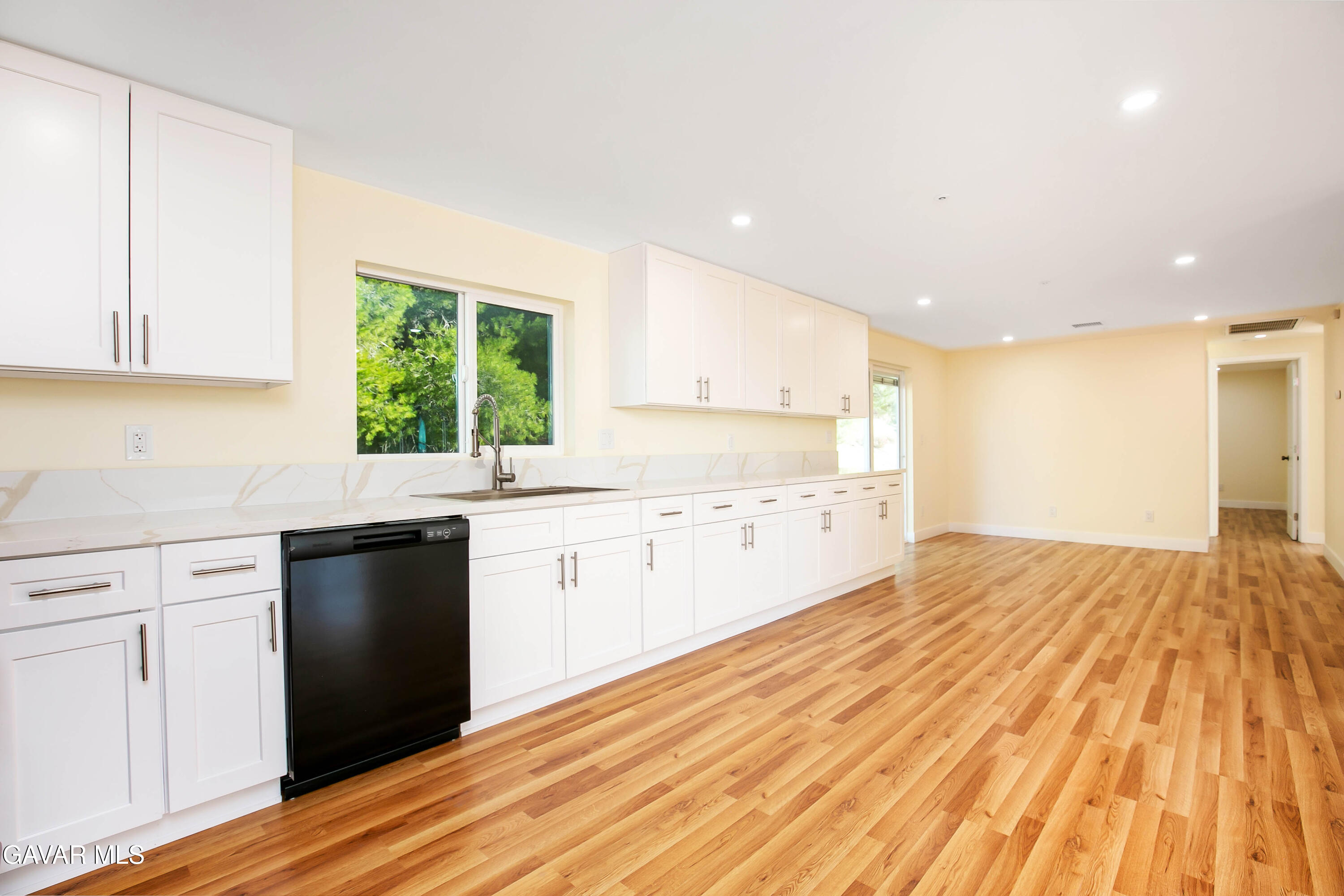 32010 Quirk Road Acton, CA 93550 - Photo 8 of 38 a kitchen with granite countertop a stove a sink and dishwasher with wooden floor