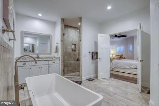a bathroom with a granite countertop double vanity sink and mirror