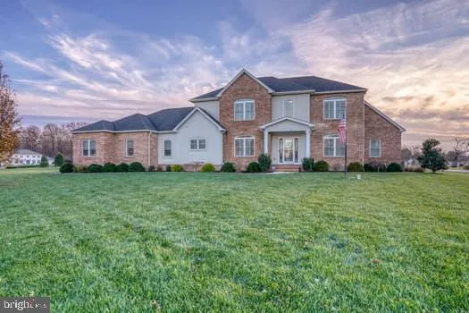 a large kitchen with stainless steel appliances kitchen island granite countertop a refrigerator and a sink