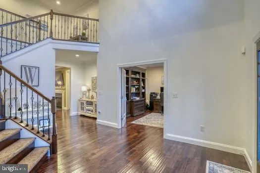 an aerial view of a house with swimming pool and a yard