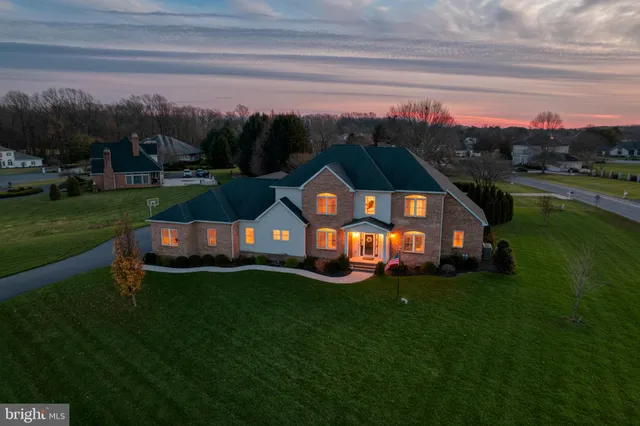 an aerial view of a house with garden space and outdoor seating