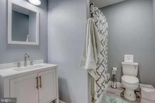 a kitchen with granite countertop a refrigerator oven a sink and white cabinets