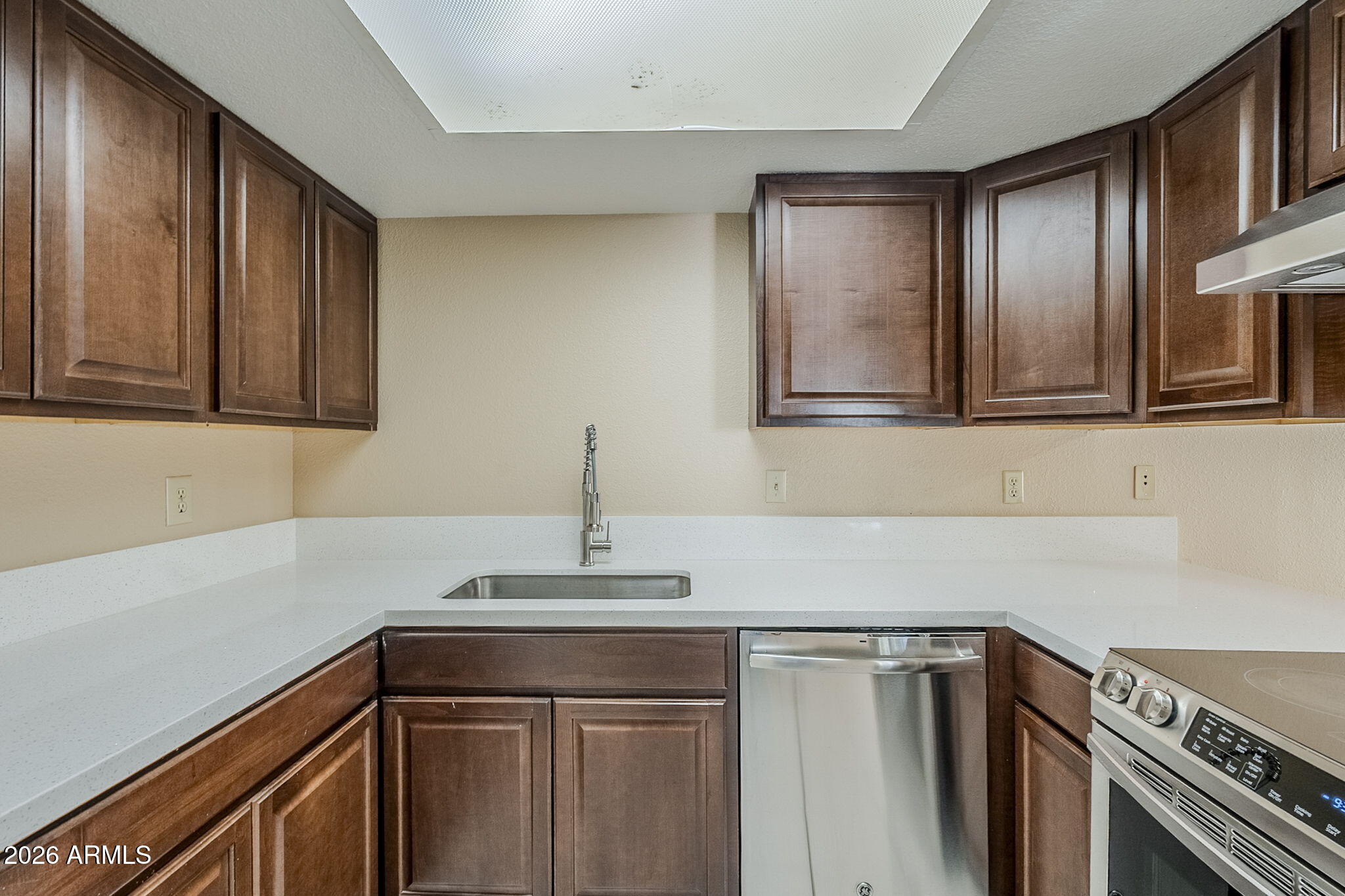 1051 South Dobson Road, Unit 128 Mesa, AZ 85202 - Photo 11 of 30 a kitchen with stainless steel appliances granite countertop a sink and cabinets