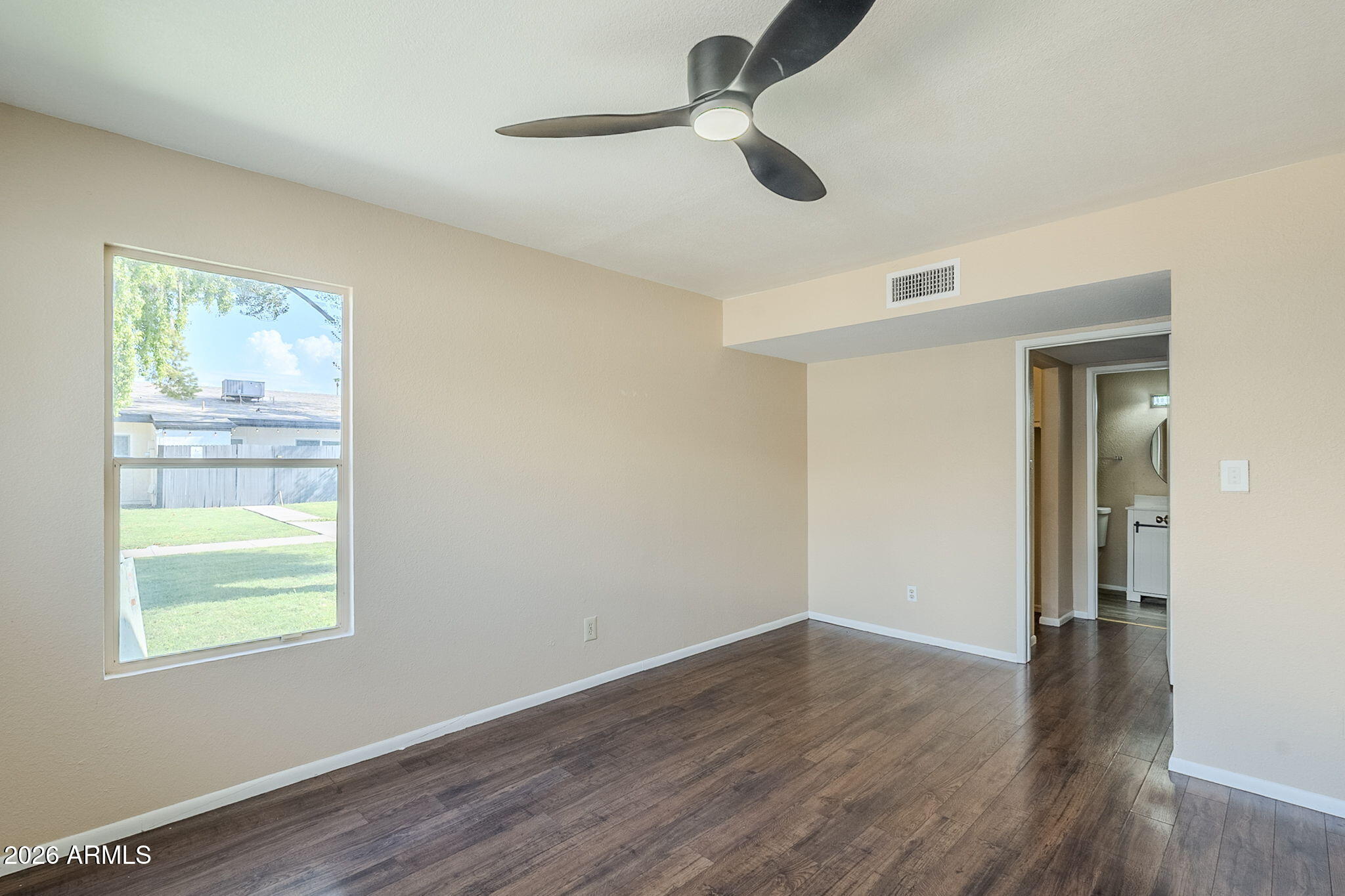1051 South Dobson Road, Unit 128 Mesa, AZ 85202 - Photo 22 of 30 a view of empty room with wooden floor and fan