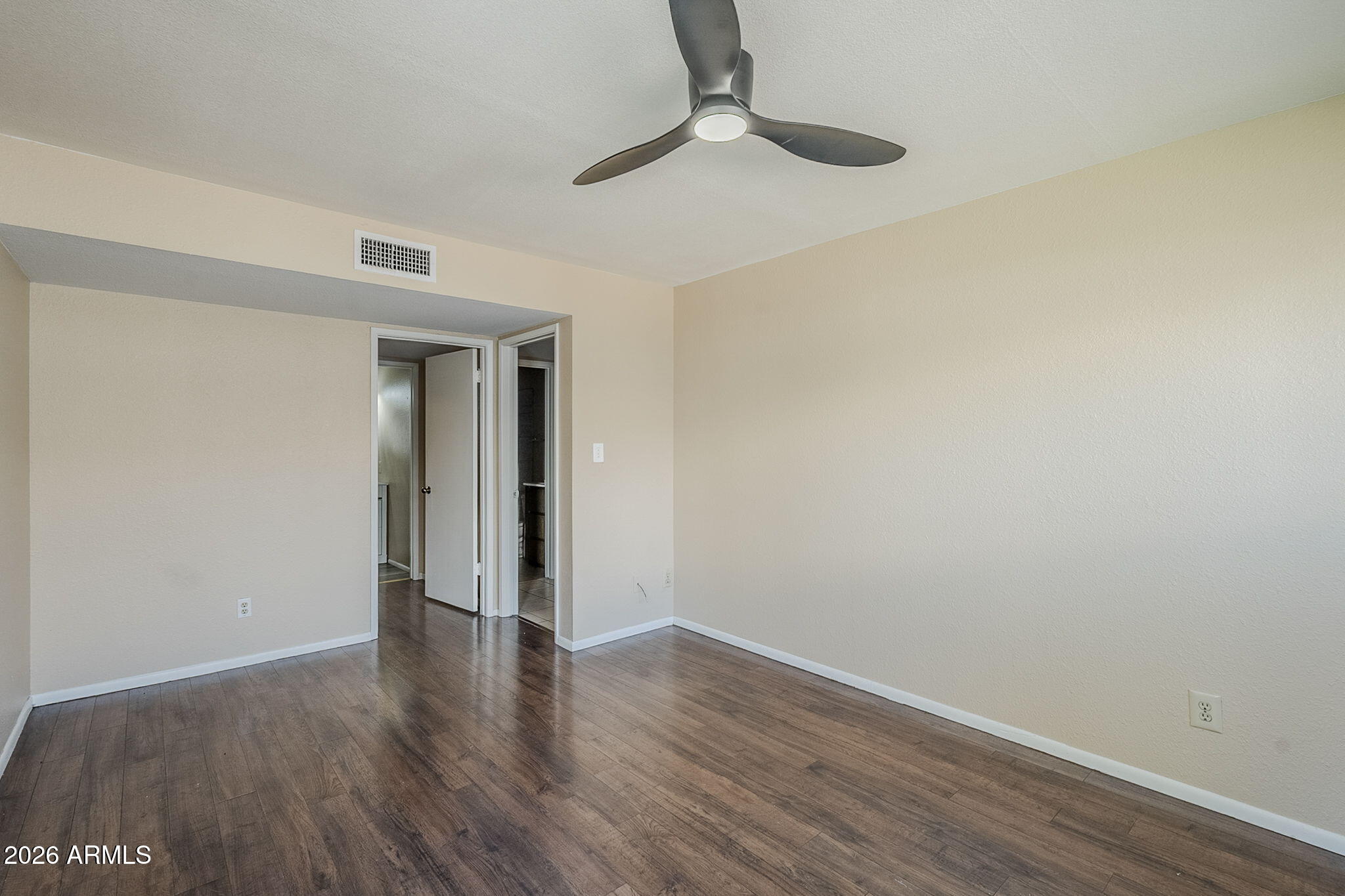 1051 South Dobson Road, Unit 128 Mesa, AZ 85202 - Photo 23 of 30 a view of an empty room with wooden floor