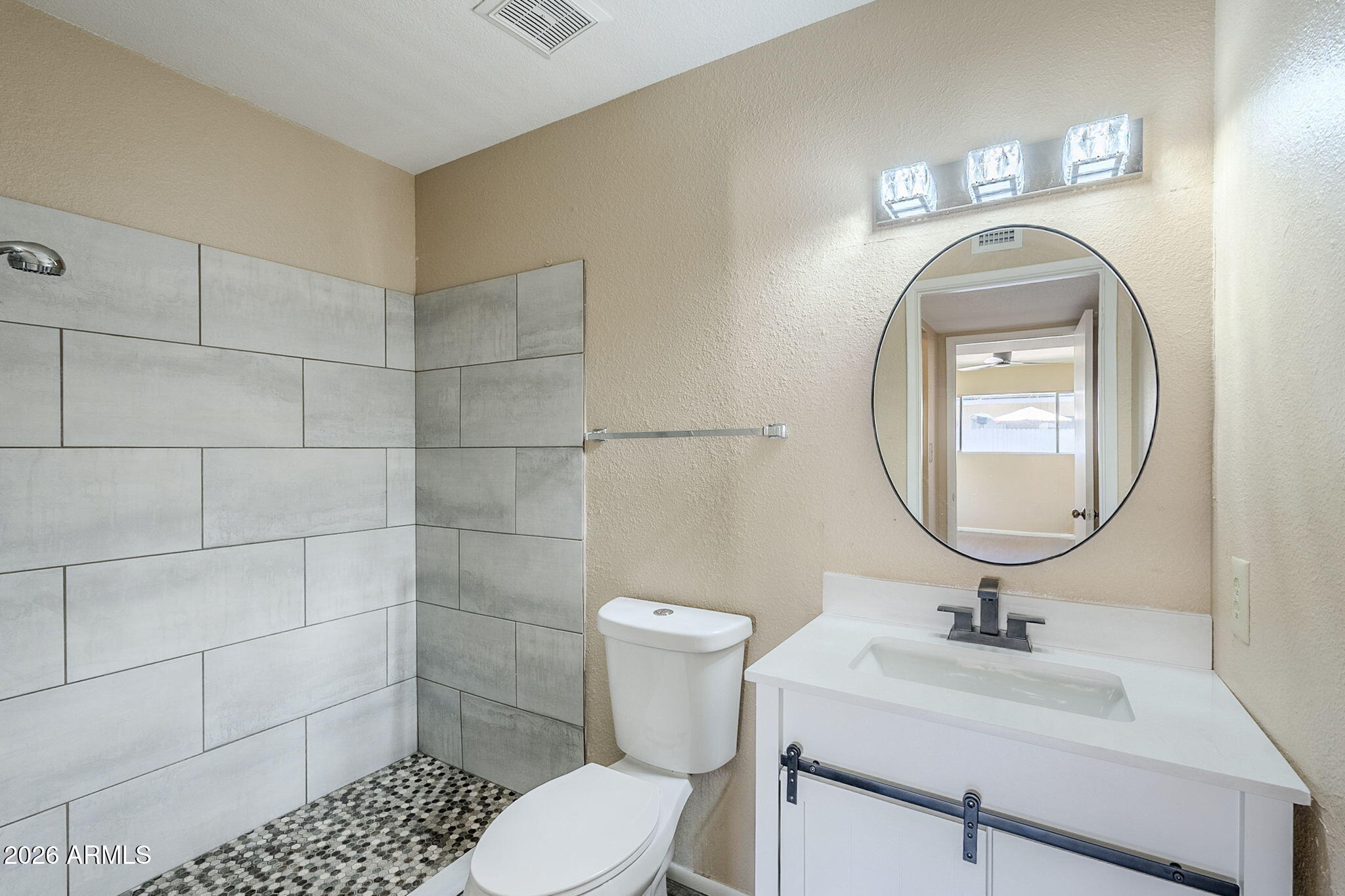 1051 South Dobson Road, Unit 128 Mesa, AZ 85202 - Photo 25 of 30 a bathroom with a toilet a sink and a mirror