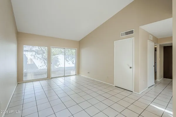 a living room with stainless steel appliances kitchen island granite countertop a refrigerator a stove and a sink