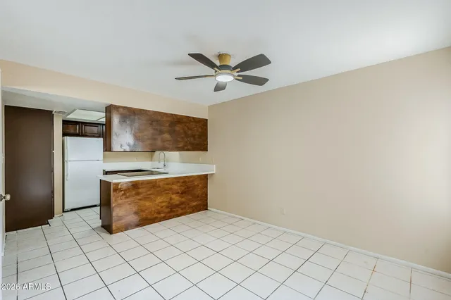 a living room with stainless steel appliances kitchen island granite countertop furniture and a view of kitchen