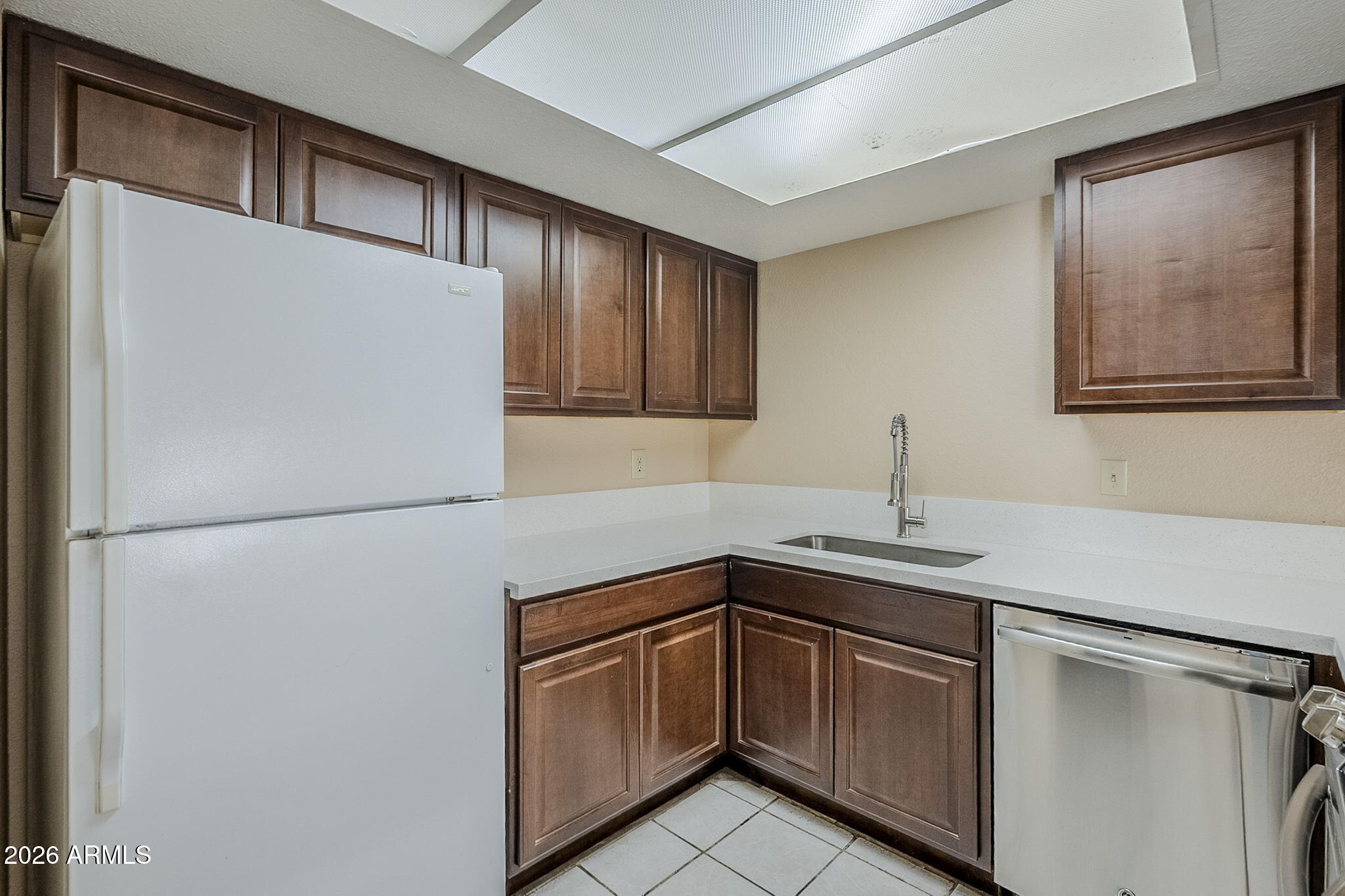 1051 South Dobson Road, Unit 128 Mesa, AZ 85202 - Photo 10 of 30 a kitchen with a sink and a refrigerator