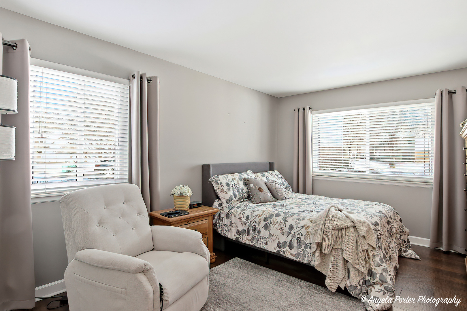 1516 Camden Court, Unit A1 Wheeling, IL 60090 - Photo 12 of 25 a bedroom with a bed and a couch with window