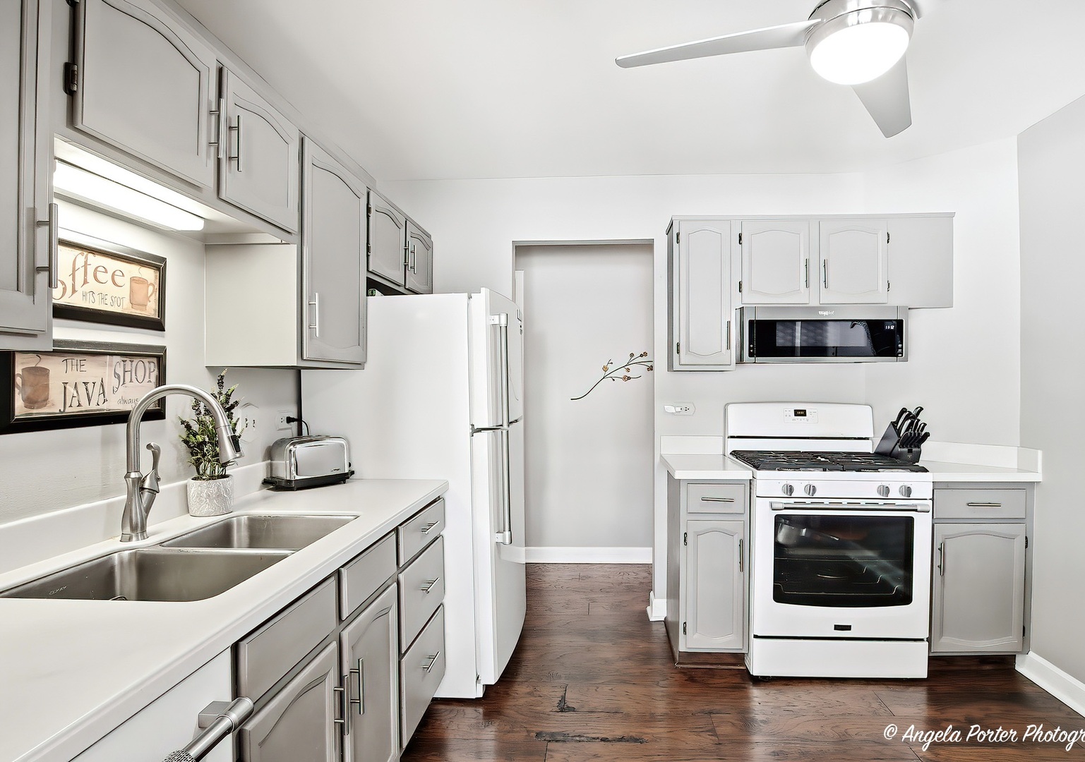 1516 Camden Court, Unit A1 Wheeling, IL 60090 - Photo 8 of 25 a kitchen with white cabinets and white appliances
