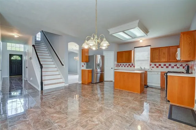 a view of a kitchen with a sink and dishwasher in kitchen