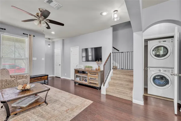 a living room with furniture and a wooden floor