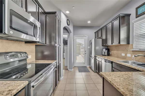 a kitchen with lots of counter top space and dining table