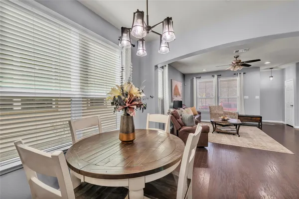 a view of a dining room with furniture and chandelier