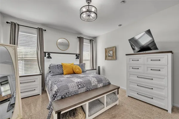 a bedroom with a large bed and a dresser