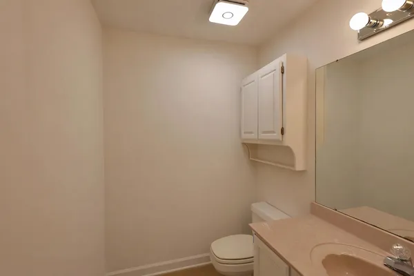 an empty room with windows and chandelier fan