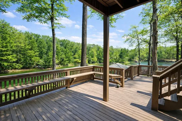 a view of a wooden deck with trees in the background