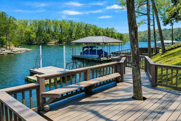 a view of a roof deck with chair and wooden floor