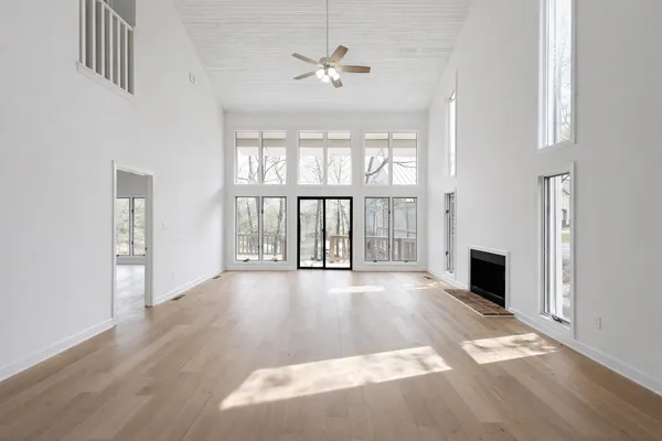 wooden floor in an empty room with a fireplace