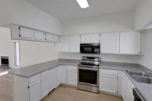 a white toilet sitting next to a shower