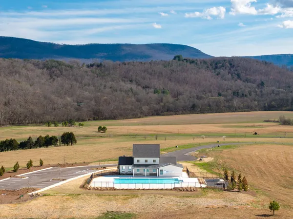 a view of a swimming pool with a lake view and mountain view