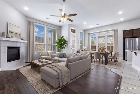an empty room with wooden floor chandelier fan and windows
