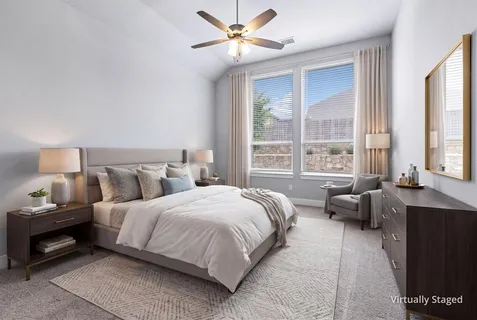 a bedroom with bed and a potted plant