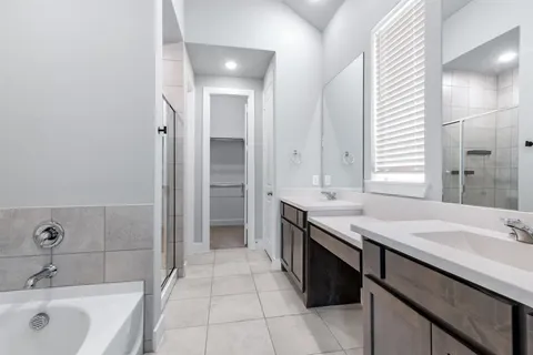 a bathroom with a granite countertop sink a mirror and a bathtub