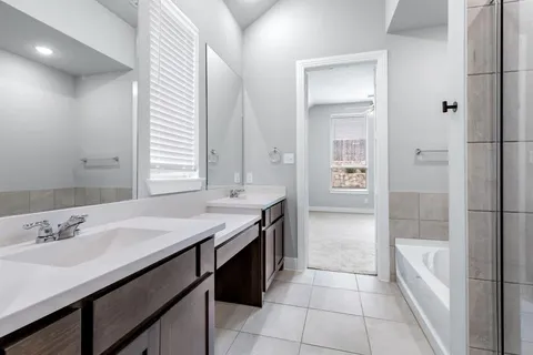 a white bath tub sitting next to a shower