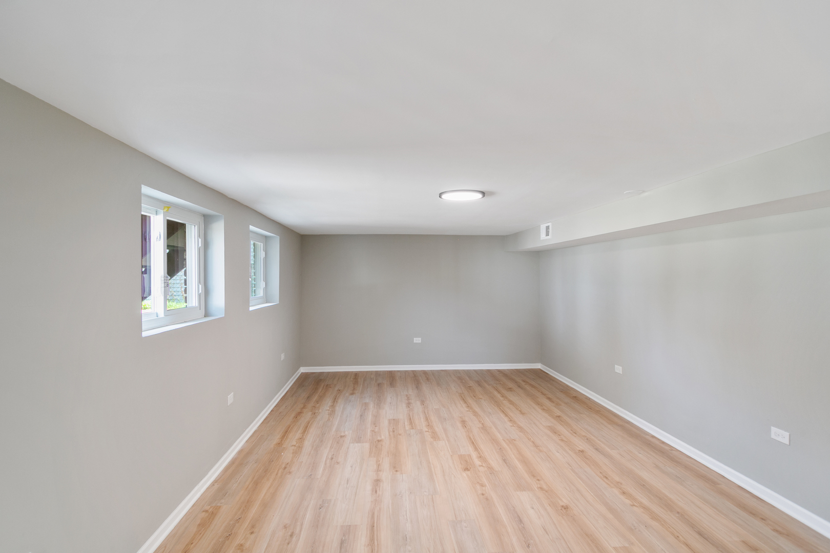 118 Windsor Lane Glendale Heights, IL 60139 - Photo 11 of 23 wooden floor in an empty room with a window