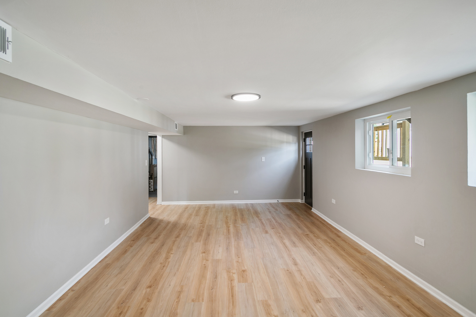 118 Windsor Lane Glendale Heights, IL 60139 - Photo 12 of 23 an empty room with wooden floor and windows