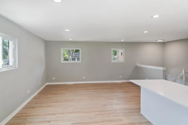 a view of a room with wooden floor and window