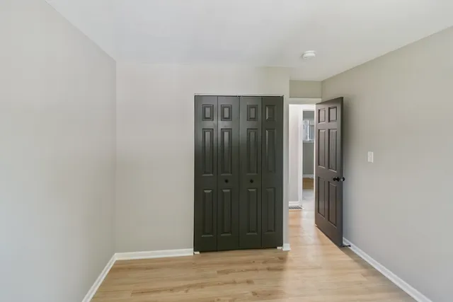 a view of a small space with wooden floor and a window
