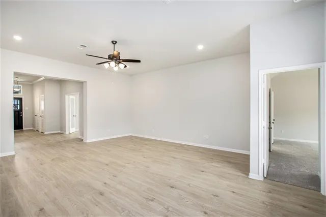 a view of an empty room with a ceiling fan