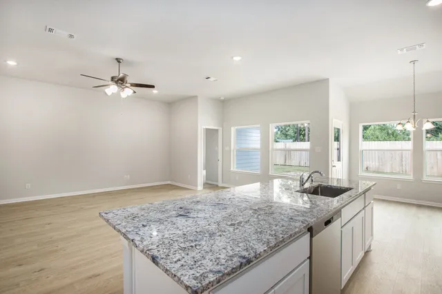 a kitchen with stainless steel appliances granite countertop a sink and a granite counter tops