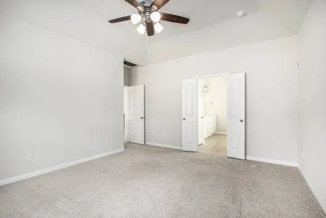 an empty room with a empty space and a ceiling fan