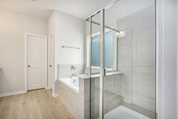 a bathroom with a bathtub and a shower