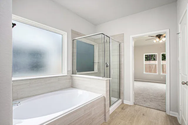 a bathroom with a bathtub and a shower