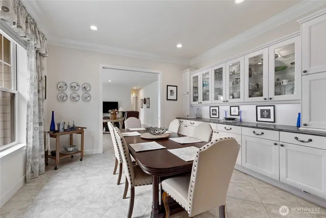 a view of a dining room with furniture and chandelier