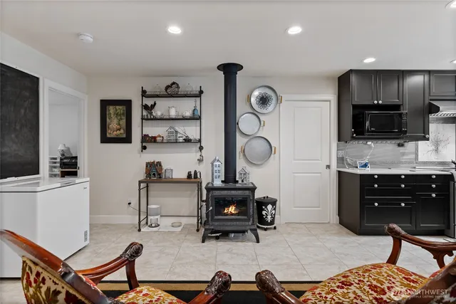 a room with furniture a flat screen tv and kitchen view
