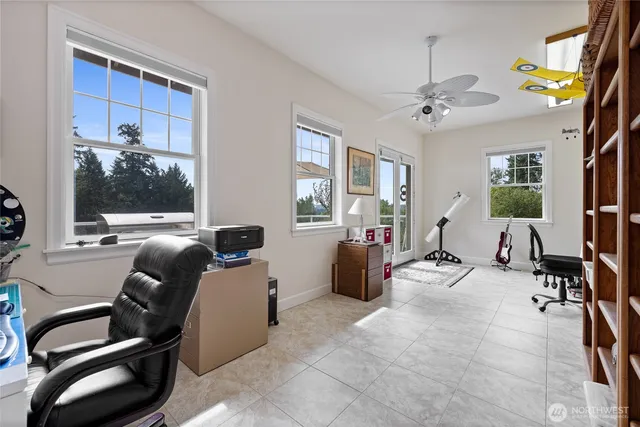 a living room with furniture a chandelier and a window