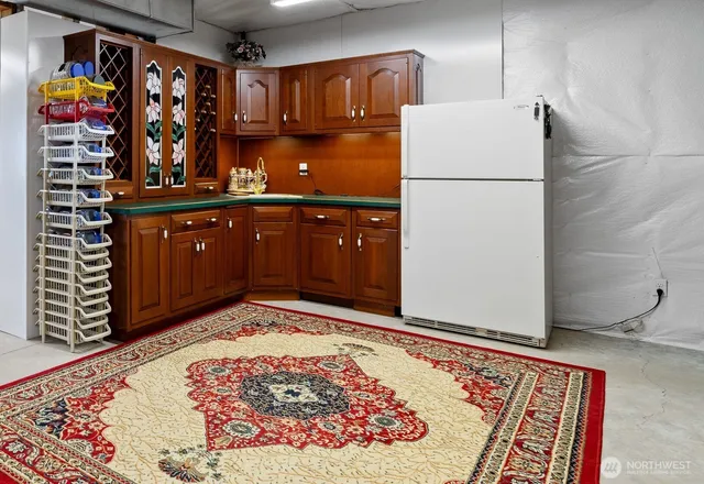 a kitchen with stainless steel appliances granite countertop a refrigerator and a stove