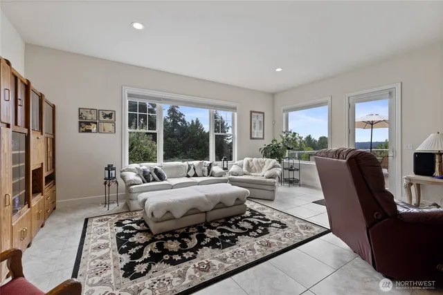 a living room with furniture large window and a flat screen tv