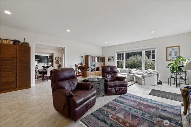 a living room with furniture potted plant and a window