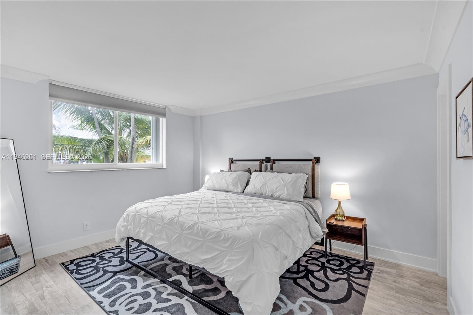 4502 North Federal Highway, Unit 167H Lighthouse Point, FL 33064 - Photo 12 of 31 a bedroom with a bed and a window with a chair
