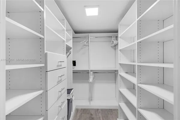 a view of walk in closet with empty racks